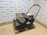 a close up of a machine on a pallet in front of a wall