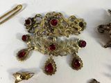 a lot of jewelry that is laying out on the table