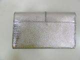 an image of a silver purse sitting on top of a white table