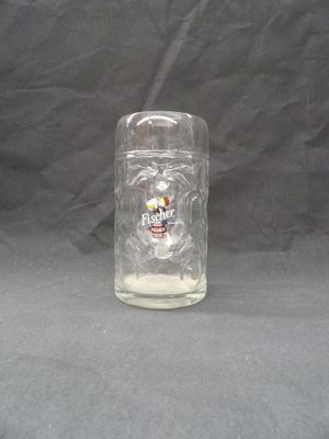 a glass jar with a skull on it sitting on a table