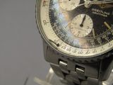 a close up of a watch on display on a stand