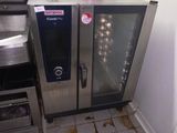 a dirty floor in a kitchen with a microwave and oven
