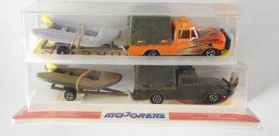 three toy vehicles in a clear box on a white surface