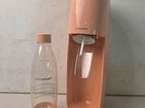 a bottle of water next to a water dispenser on a counter