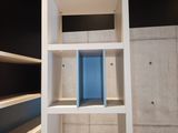 a white book shelf with books on it in a room