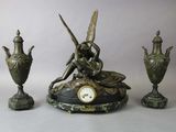a clock sitting on top of a table next to two vases and a clock