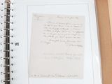 a picture of a book with a handwritten letter on it