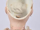 a doll that has a bowl on it ' s head
