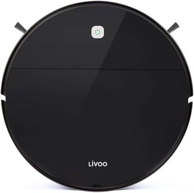 un aspirateur robot noir sur une surface blanche