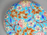 a blue plate with flowers on it on a table