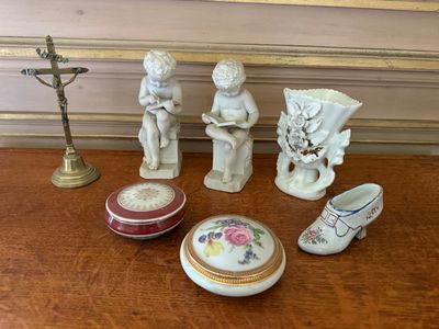 a small collection of porcelain figurines on a table