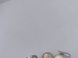 two rings and a pair of earrings sitting on a table