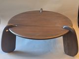 a wooden table with a metal handle on it