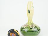 yellow and green vase and measuring tape on a white background