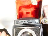 a person holding an old camera in their hand