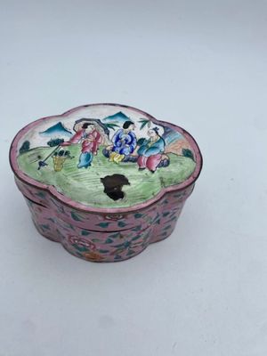 a small bowl with a painting on it sitting on a table