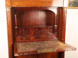 a wooden cabinet with a marble top in a room