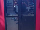 a tall black cabinet with a mirror on the door