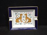 a blue and white plate with a picture of two leopards on it