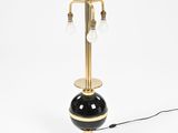 a black and gold table lamp on a white background