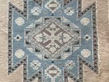 a close up of a rug with a blue and brown design on it