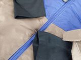 a jacket that has a zipper on the front and a zipper on the back of the jacket
