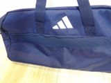 a blue duffel bag with a white logo on it