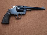 a close up of a revolver on a brown surface