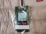 a tag attached to the back of a jacket with a norway flag on it