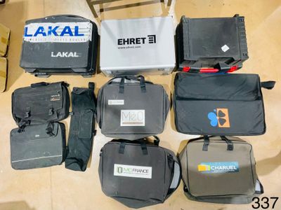 several pieces of luggage are laid out on the floor next to a chair