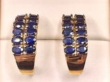 pair of blue sapphire and diamond hoop earrings in a box