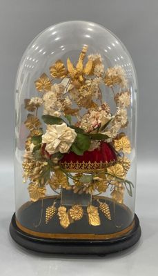 a glass dome with flowers inside of it on a table