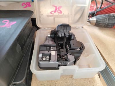 two cameras in a plastic box on a table