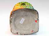 a close up of a vase with a tag on it