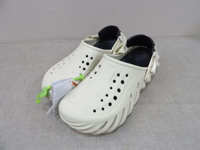 a pair of shoes that are on a bed