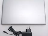 a laptop with a charger attached to it on a table