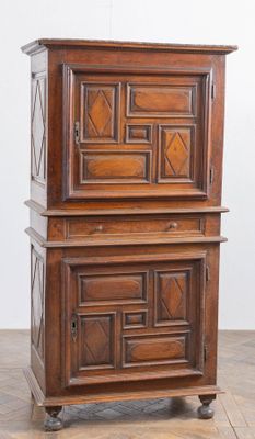 an old wooden cabinet sitting on top of a hard wood floor
