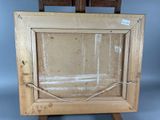 an old picture frame with a rope around it on a wooden easel