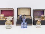 several different types of perfume bottles are lined up on a white surface