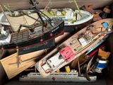 a box full of toy boats and other toys