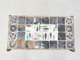 a picture of a tile with fish and leaves on it