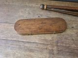 two baseball bats and a wooden case on a table