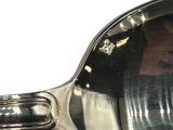 a reflection of a man in a mirror on a spoon