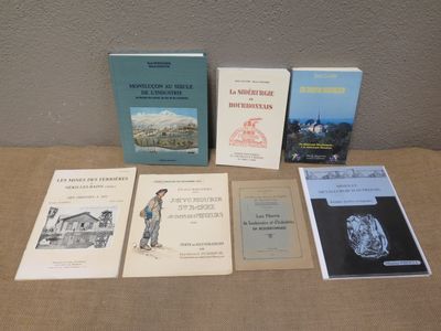 several books sitting on a table next to each other on top of a table