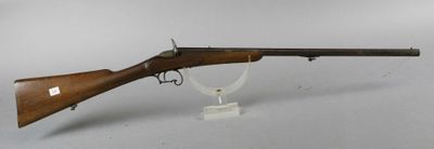 an old rifle with a wooden barrel on a clear stand