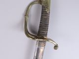 an old sword with a gold handle on a white background