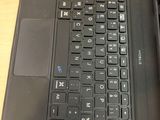 a laptop with a black keyboard on a wooden table
