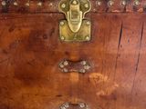 a wooden trunk with brass hardware on it