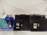 three black briefcases sitting on a shelf next to each other