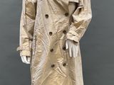 an image of a mannequin wearing a trench coat and hat